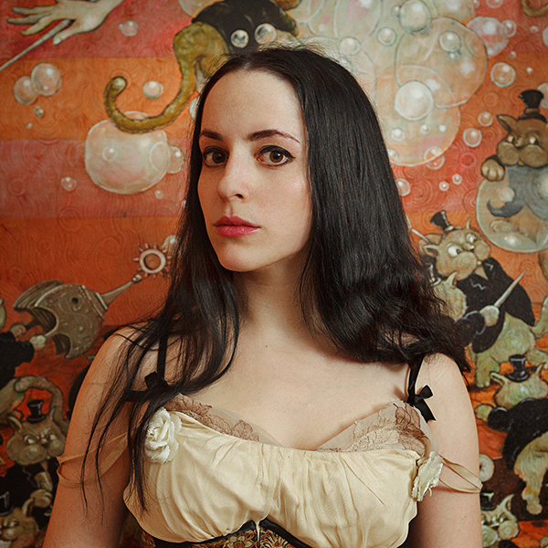 Molly Crabapple,  her posing in front of her Shell Game Series, 2012